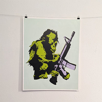 stencil painting young orangutan holding an assault rifle